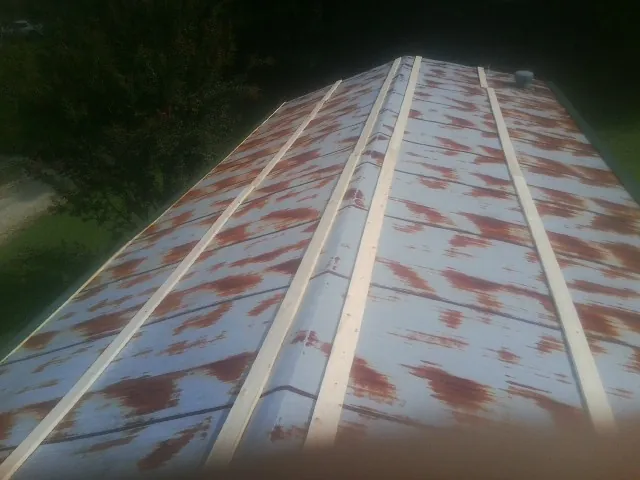 Rusted metal roof panels with new wood purlins before replacement — Storm Damage Roof Repair in Mount Olivet by Roofing Brothers